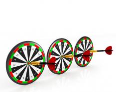 Dart hitting target showing concept of business success stock photo