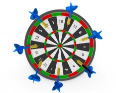 Darts hitting on board showing business target concept stock photo