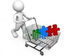 Different colored puzzle in cart with 3d man stock photo
