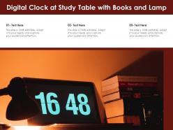 Digital clock at study table with books and lamp