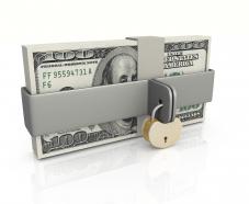Dollar bundle with lock over financial safety stock photo