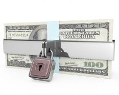Dollar bundles protected with chain and clock stock photo