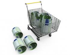 Dollar Rolls In And Outside Shopping Cart For Marketing And Sales Stock Photo