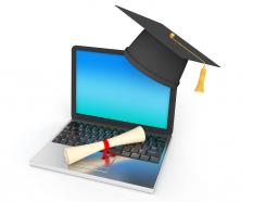 E learning concept with laptop and graduation cap with degree stock photo