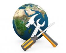 Earth globe with hammer wrench screwdriver technology tools stock photo
