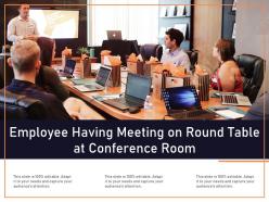 Employee having meeting on round table at conference room
