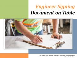 Engineer signing document on table