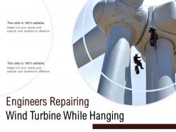 Engineers repairing wind turbine while hanging