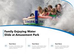 Family enjoying water slide at amusement park