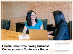 Female executives having business conversation in conference room