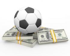 Football residing above dollars stock photo