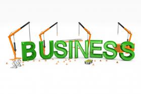 Four cranes with business text word stock photo