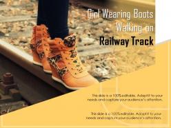Girl wearing boots walking on railway track