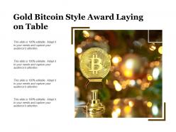 Gold bitcoin style award laying on table