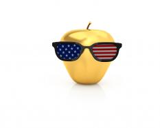 Golden apple with goggles made of flag stock photo