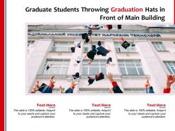 Graduate students throwing graduation hats in front of main building
