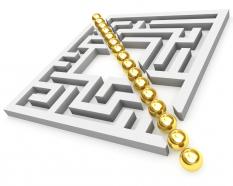 Graphic of square maze with golden line in middle stock photo