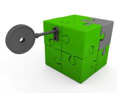 Green cube made of puzzles with key for security stock photo