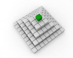 Green cube on top as leader with white cube pyramid stock photo