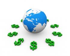 Green dollar signs around globe for international economy stock photo