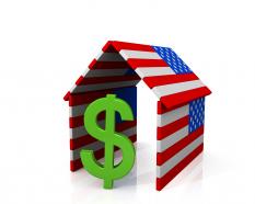 Green dollar symbol inside the house made of american flag stock photo