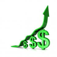 Green growth arrow on dollars bar graph stock photo