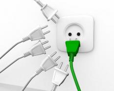 Green plug with white plugs and one socket for leadership stock photo