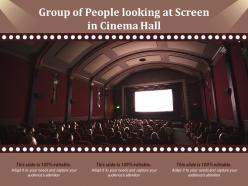 Group of people looking at screen in cinema hall