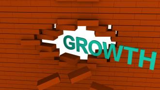 Growth text coming out from brick wall stock photo