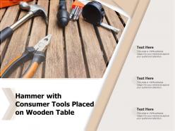 Hammer with consumer tools placed on wooden table