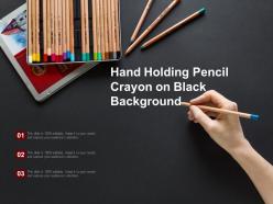 Hand holding pencil crayon on black background