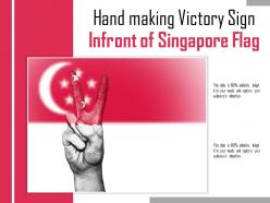 Hand making victory sign infront of singapore flag