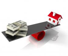 House With Balance Money On Balancing Scale Stock Photo
