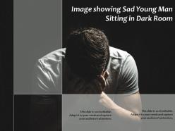 Image showing sad young man sitting in dark room
