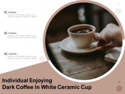 Individual enjoying dark coffee in white ceramic cup