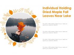 Individual holding dried maple fall leaves near lake