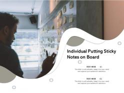 Individual putting sticky notes on board