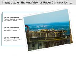 Infrastructure showing view of under construction site with workers and tall crane