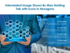 Interrelated image shown by man holding tab with icons in hexagons