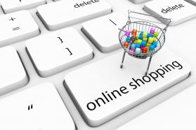 Keyboard key of online shopping with cart full of cubes stock photo