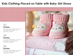 Kids clothing placed on table with baby girl shoes