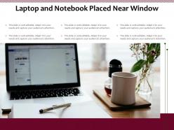 Laptop and notebook placed near window