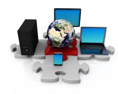 Laptop computer with globe and server graphic on puzzle stock photo