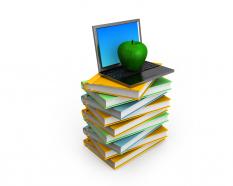 Laptop with apple on books stack stock photo