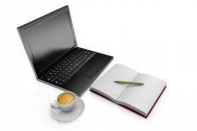 Laptop with cup of coffee and notebook stock photo