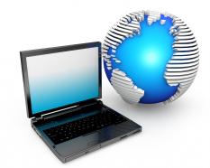 Laptop with globe displaying technology stock photo