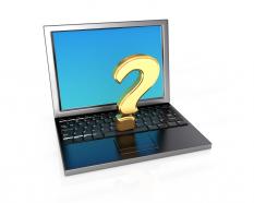 Laptop with question mark stock photo