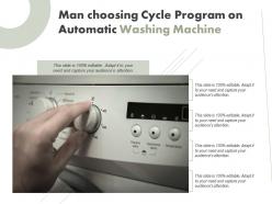 Man choosing cycle program on automatic washing machine