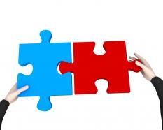 Man fixing red and blue puzzle to display problem solving stock photo