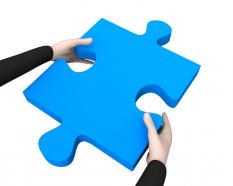 Man holding blue puzzle in hand stock photo